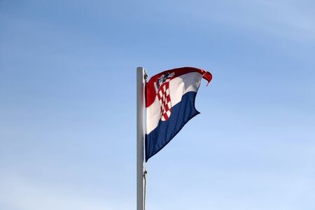 Flag of Croatia, blowing in the wind. Clear blue sky in the background.の写真素材