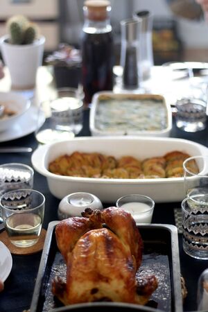 Marinated roast chicken on a table. Table setting for big family lunch. Selective focus.の写真素材