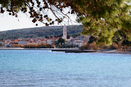 Small town Supetar on island Brac, Croatia, surrounded with sea and pine trees. Selective focus.の写真素材