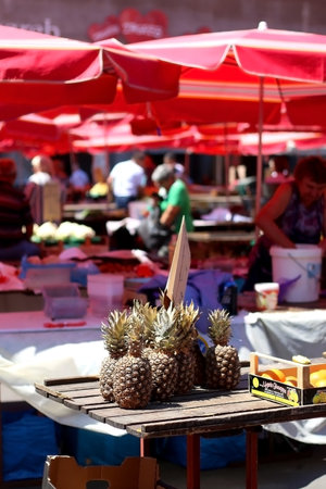 Zagreb, Croatia - June 20, 2017: People buying and selling fresh produce on Dolac Market in Zagreb, Croatia on a sunny day. Dolac market is famous for its traditional red parasols.のeditorial素材