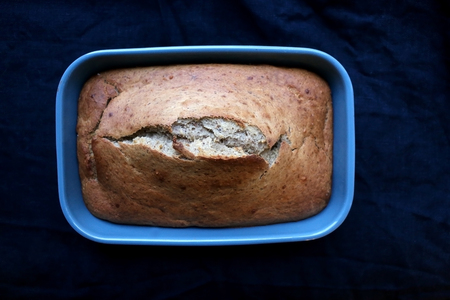 Homemade baked banana bread on a dark blue tablecloth. Selective focus.の写真素材