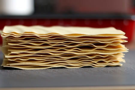 Stack of uncooked lasagna noodles. Selective focus.の写真素材