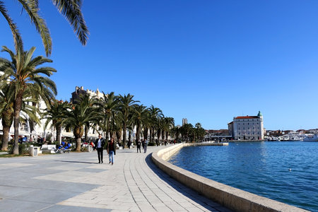 Split, Croatia - February 7, 2019: People enjoying sunny day on Riva promenade in Split, Croatia. Split is popular summer travel destination.のeditorial素材