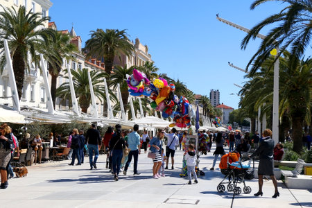 Split, Croatia - April 6, 2019: Tourists and locals enjoying sunny spring day on Riva promenade in Split, Croatia.のeditorial素材