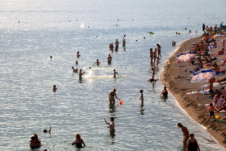 Sibenik, Croatia - August 20, 2018: Crowd enjoying sunny summer day on Banj beach in Sibenik, Croatia. Sibenik is popular summer travel destination.のeditorial素材