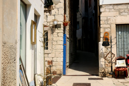 Sibenik, Croatia - August 20, 2018: Antique furniture and vintage art for sale on the narrow cobblestone street in central Sibenik, Croatia.のeditorial素材