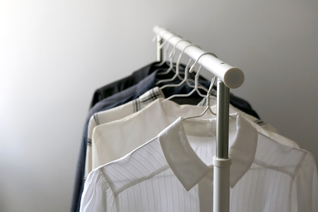 Minimal capsule wardrobe on a clothes rack. Selective focus.の写真素材