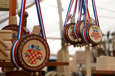 Split, Croatia - May 7, 2019: Traditional wooden wine bottles with Croatian coat of arms - souvenir for sale in Croatia.のeditorial素材