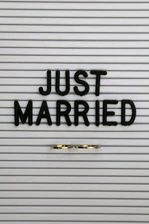 Bulletin board with wedding rings and love message. Wedding concept.の写真素材