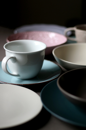 Collection of pottery and kitchenware in muted pastel colors. Selective focus.の写真素材