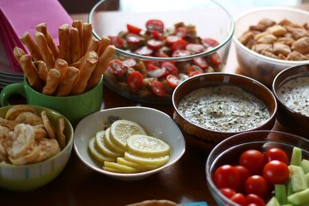 Table setting with galette, snacks, dips and salads. Selective focus.の写真素材