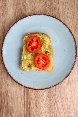 Toast with mashed avocado, cherry tomato and smoked pepper. Top view.の写真素材