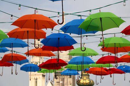 Colorful umbrellas on the street of Zagreb, Croatia. Cathedral of the Assumption of the Blessed Virgin Mary in the background. Selective focus.の写真素材