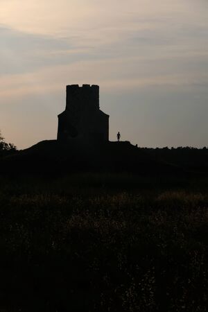 Silhouette of small medieval church of St. Nicholas and visitors around, near Nin, Croatia.の写真素材
