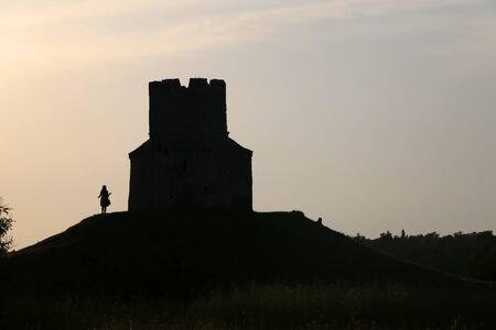 Silhouette of small medieval church of St. Nicholas and visitors around, near Nin, Croatia.の写真素材