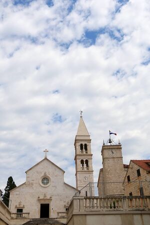 Historic parish Church of Mary's Annunciation and clock tower Leroj in Supetar, island Brac,...