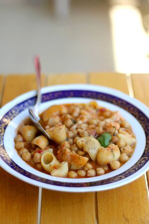 Plate of pasta, chickpea and shrimp stew. Selective focus.の写真素材