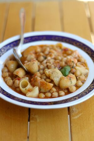 Plate of pasta, chickpea and shrimp stew. Selective focus.の写真素材