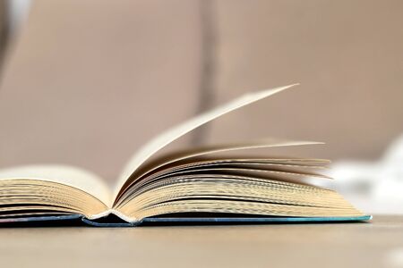 Open book on a living room table. Selective focus.の写真素材