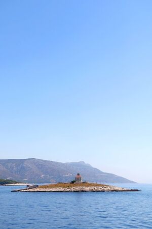 Picturesque lighthouse on a small island near town Hvar, on island Hvar, Croatia.の写真素材