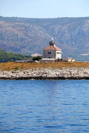 Picturesque lighthouse on a small island near town Hvar, on island Hvar, Croatia.の写真素材