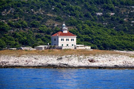 Picturesque lighthouse on a small island near town Hvar, on island Hvar, Croatia.の写真素材