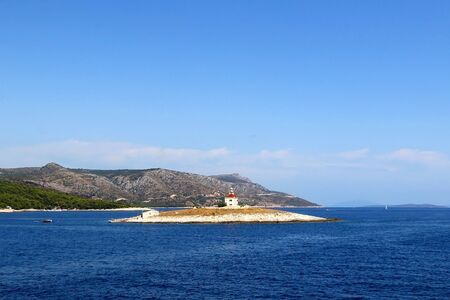 Picturesque lighthouse on a small island near town Hvar, on island Hvar, Croatia.の写真素材