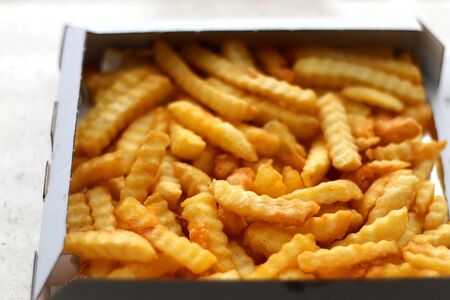 Curly fries in a box. Take away food. Selective focus.の写真素材