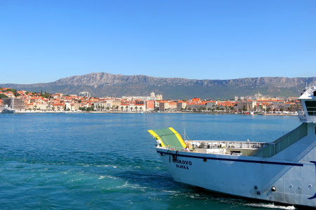 Split, Croatia - August 11, 2019: Ferry boat and promenade in Split, Croatia on bright summer day.のeditorial素材