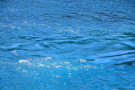 Sea surface in deep blue and turquoise tones. Selective focus.の写真素材