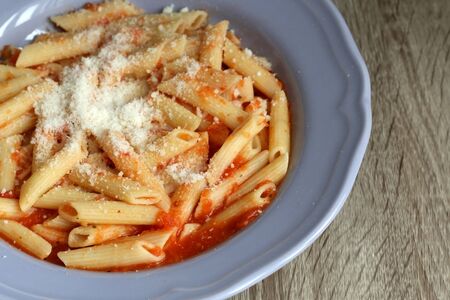 Plate of pasta with homemade tomato sauce. and grated parmesan cheese on top. Selective focus.の写真素材