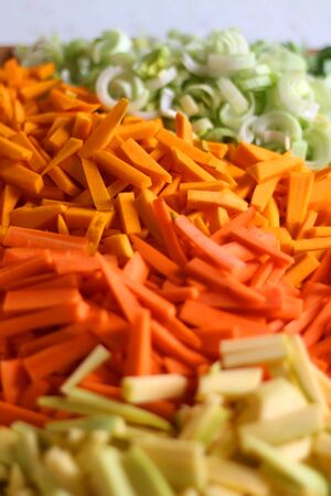 Chopped leek, pumpkin, carrot and zucchini on a cutting board. Selective focus, close-up.の写真素材