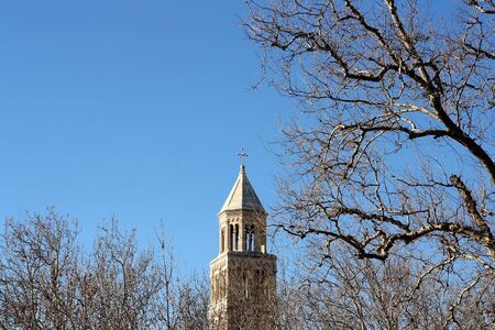 Saint Domnius bell tower, landmark in Split, Croatia, surrounded by bare winter trees.の写真素材