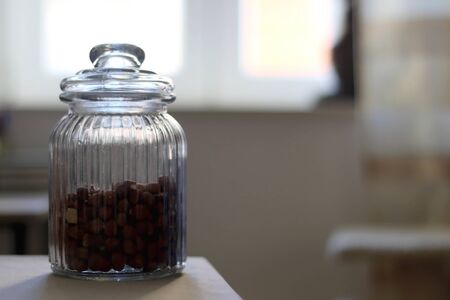 Hazelnuts in a jar on a table. Selective focus.の写真素材