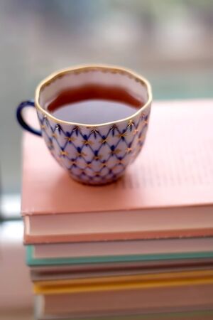Cup of tea on pink book. Selective focus.の写真素材