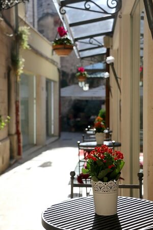 Flowers and tables in a picturesque alley in central Split, Croatia.の写真素材