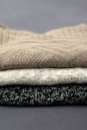 Pile of sweatres in neutral colors. Selective focus.の写真素材