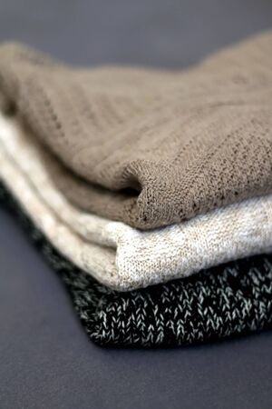 Pile of sweatres in neutral colors. Selective focus.の写真素材