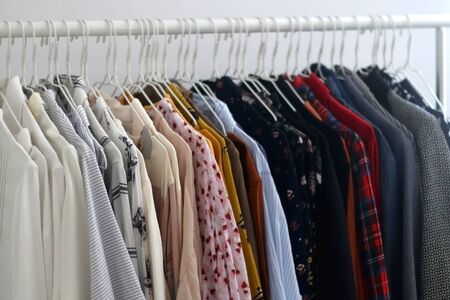 Color coded clothing on a rack. Selective focus.の写真素材