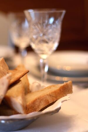 Homemade bread and crystal glass on a holiday table. Selective focus.