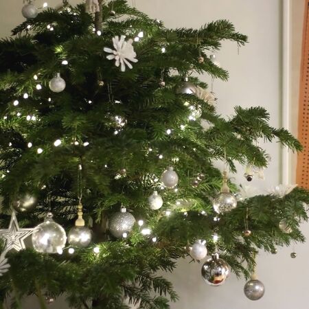Christmas tree with white and silver decorations. Selective focus.の写真素材