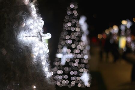 Illuminated star on an outdoor christmas tree at night. Selective focus.の写真素材