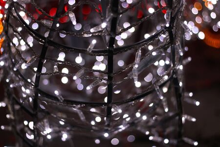 Outdoor Christmas decoration with silver colored lights at night. Selective focus.の写真素材