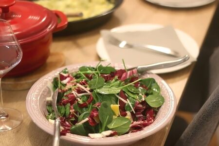 Spinach, chicory, fennel and orange salad served on the festive table setting. Selective focus.の写真素材
