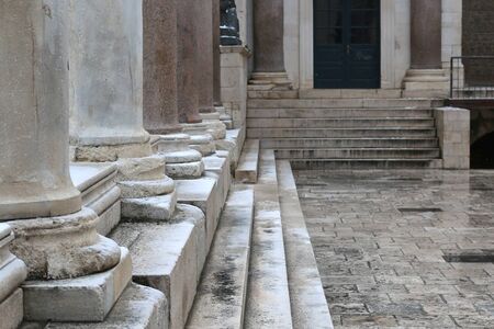 Snow falling on historic architecture on town square Peristil in Split, Croatia. Selective focus.の写真素材