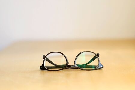 Elegant eyeglasses on a wooden table. Selective focus.の写真素材
