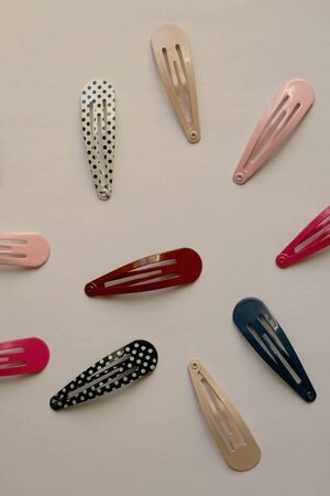 Fashionable colorful hair clips on pale background. Flat lay.の写真素材