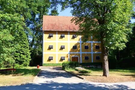 Wooden windows and yellow wall of a historic building in Zapresic, Croatia.