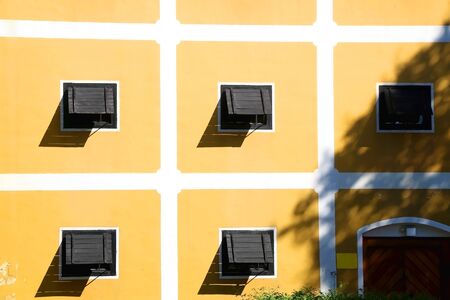 Wooden windows and yellow wall of a historic building in Zapresic, Croatia.の写真素材