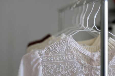 Capsule wardrobe in white and neutral tones. Selective focus.